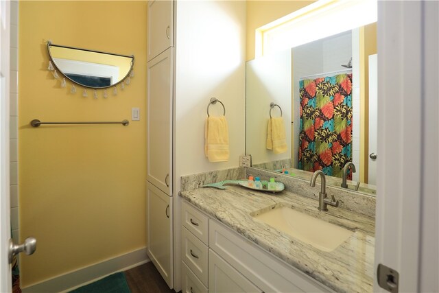 bathroom featuring hardwood / wood-style flooring and vanity