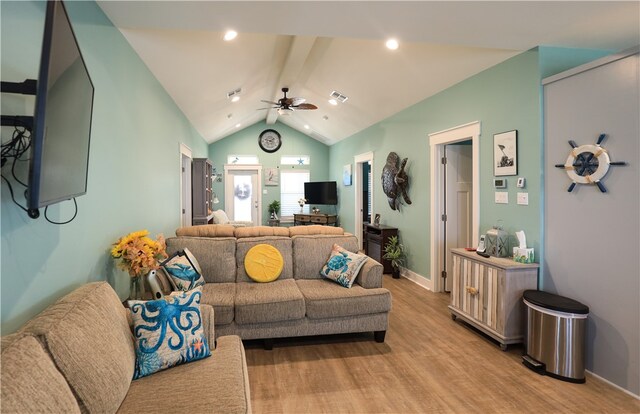 living room featuring ceiling fan, light hardwood / wood-style flooring, and vaulted ceiling with beams