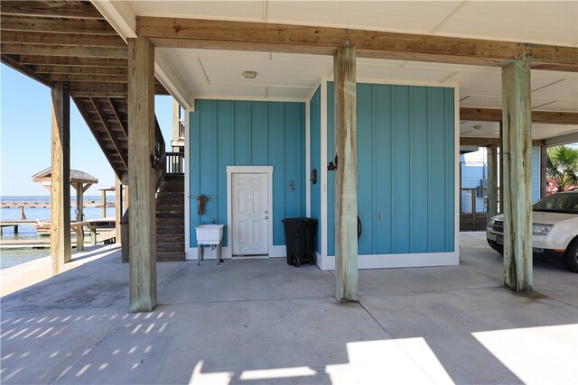 property entrance featuring a water view and a carport