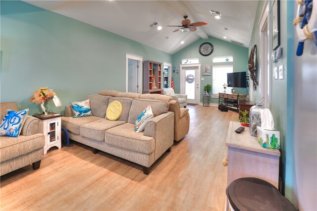 living room featuring lofted ceiling with beams, ceiling fan, and light hardwood / wood-style floors