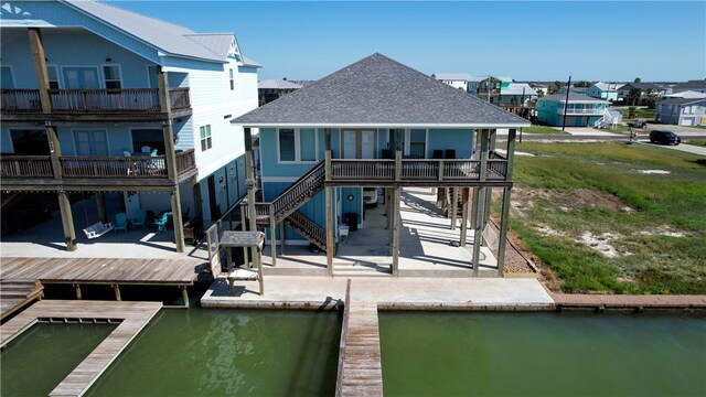 exterior space featuring a patio area and a deck with water view