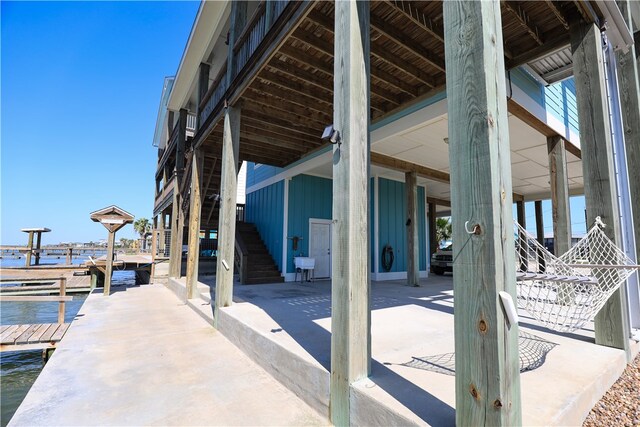 view of patio / terrace featuring a dock and a water view