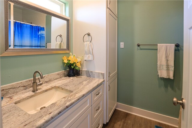 bathroom featuring hardwood / wood-style floors and vanity