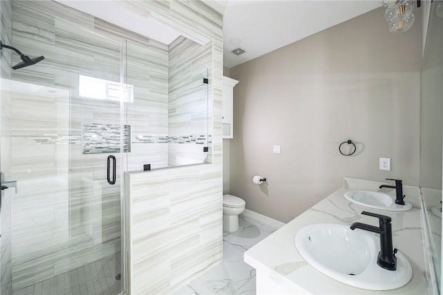 bathroom with vanity, a shower with shower door, and toilet