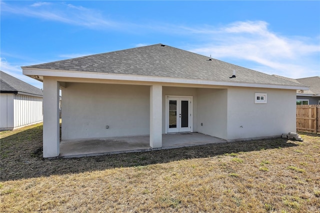 rear view of property with a yard, a patio area, and french doors