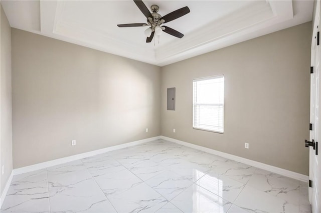 unfurnished room with a tray ceiling, electric panel, and ceiling fan