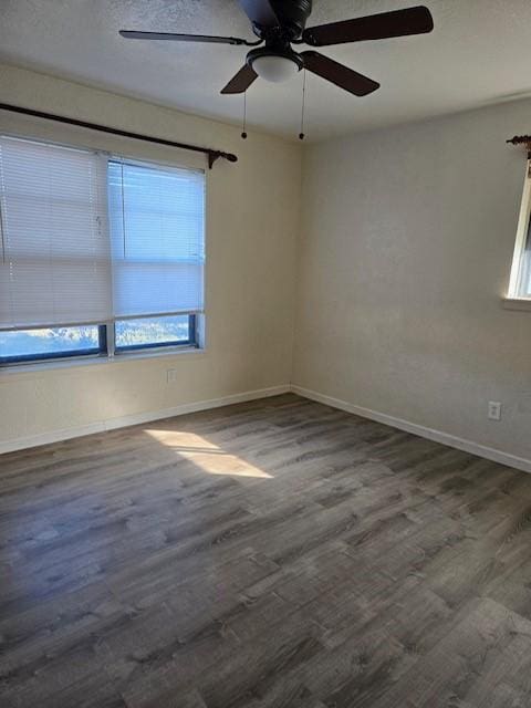 unfurnished room with ceiling fan and dark hardwood / wood-style floors