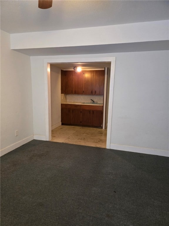 spare room with light colored carpet and sink