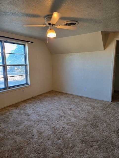 bonus room with ceiling fan, lofted ceiling, a textured ceiling, and carpet floors