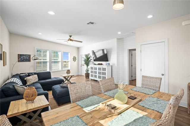 dining space with hardwood / wood-style floors and ceiling fan