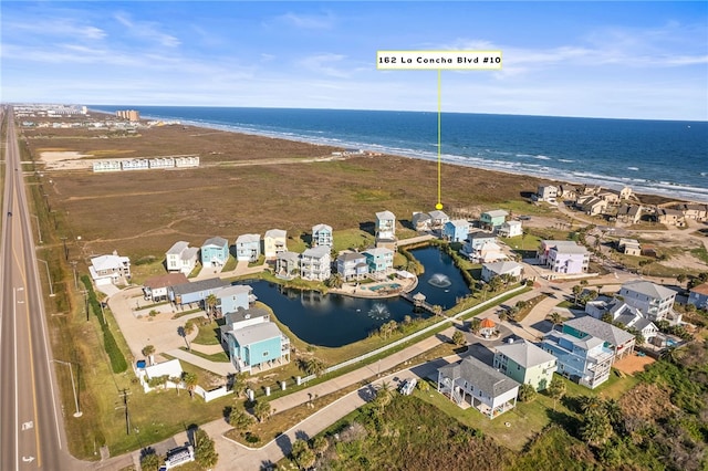 drone / aerial view with a water view and a view of the beach