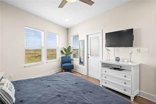 bedroom with ceiling fan and dark hardwood / wood-style floors