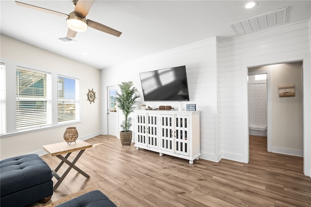 living room featuring hardwood / wood-style floors and ceiling fan