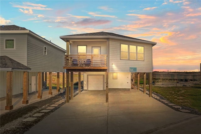 view of front of property with a balcony and a garage