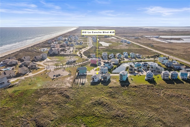 aerial view featuring a view of the beach and a water view