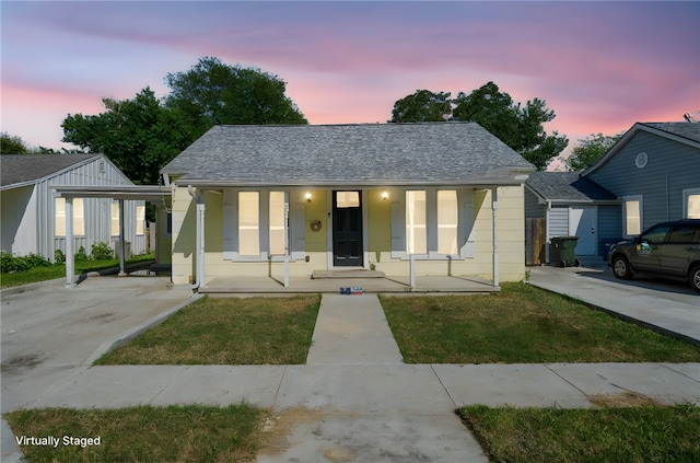 bungalow-style home featuring covered porch and a carport