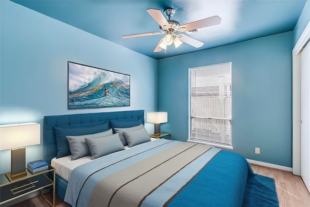 bedroom featuring hardwood / wood-style floors and ceiling fan