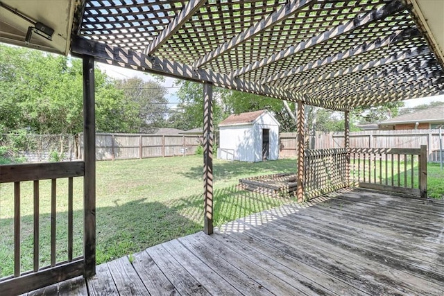 wooden deck featuring a yard and a shed