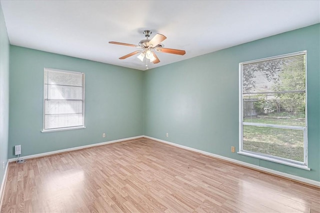 empty room with ceiling fan and light hardwood / wood-style floors