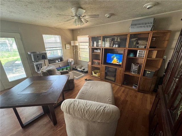 1210 Brentwood Dr, Corpus Christi, TX 78404 - living area featuring a ceiling fan, a textured ceiling, and wood finished floors
