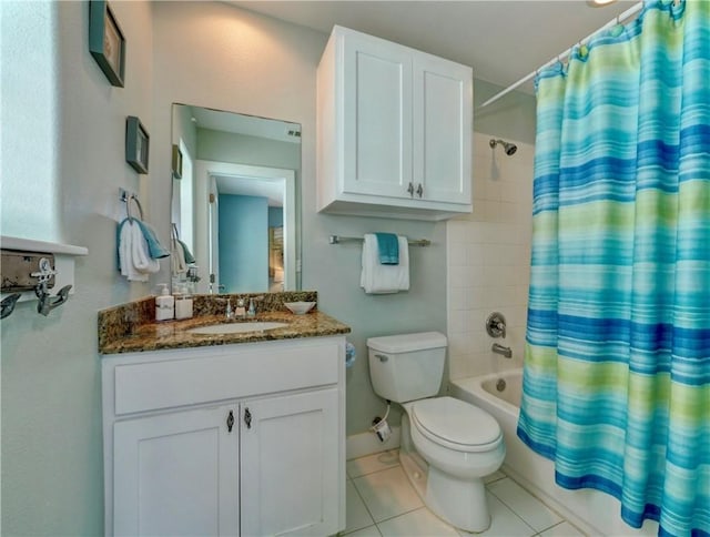 full bathroom featuring tile patterned flooring, vanity, toilet, and shower / bath combo with shower curtain