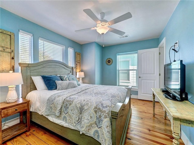 bedroom with ceiling fan and light hardwood / wood-style floors