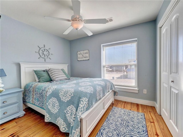 bedroom with ceiling fan, a closet, and light wood-type flooring