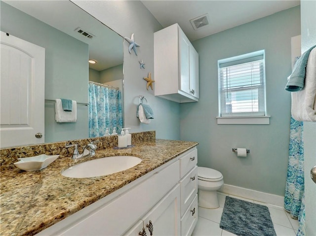 bathroom with vanity, tile patterned floors, and toilet