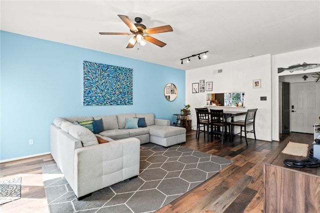 living room with ceiling fan, rail lighting, wood finished floors, and visible vents