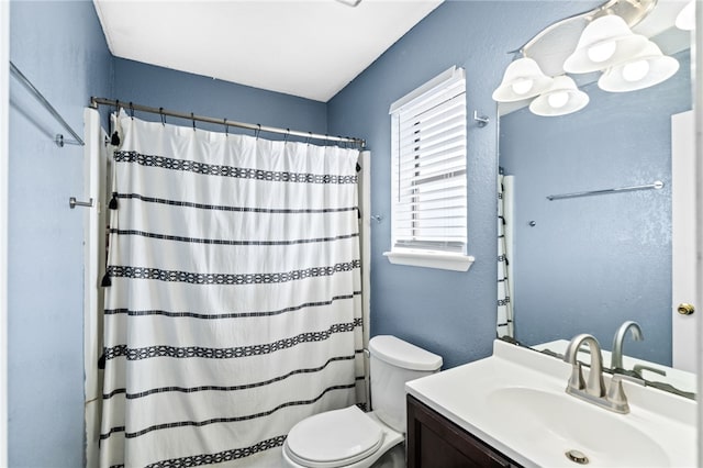 full bathroom with toilet, a textured wall, vanity, and curtained shower