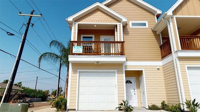 view of front facade featuring a garage and a balcony