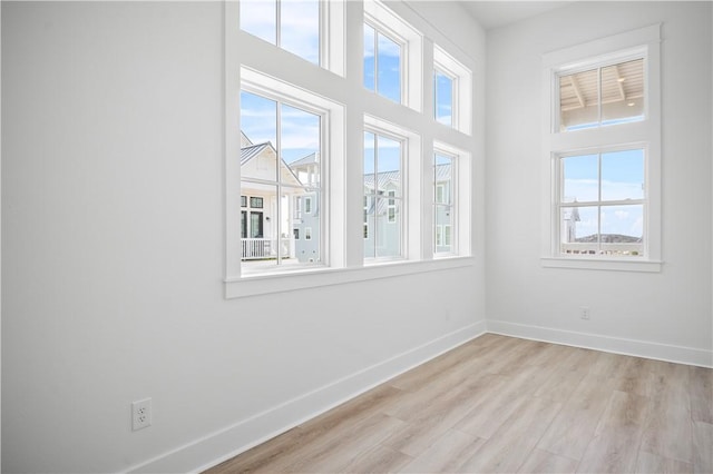 113 Spoonbill Prt, Aransas, TX 78373 - empty room featuring plenty of natural light, light wood-type flooring, and a high ceiling