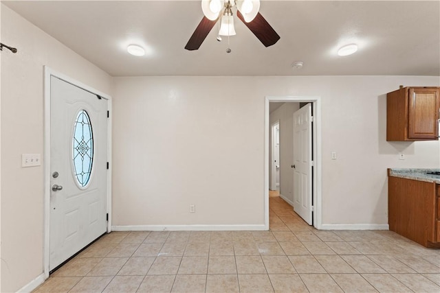 tiled foyer with ceiling fan