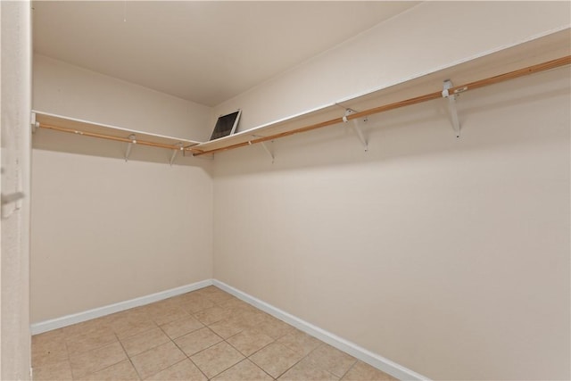 walk in closet with tile patterned floors