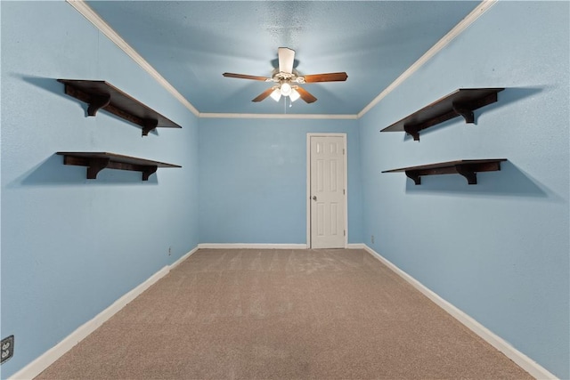 carpeted spare room with ceiling fan and crown molding