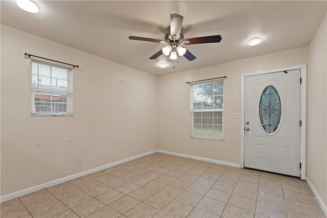 tiled entrance foyer featuring ceiling fan and a wealth of natural light