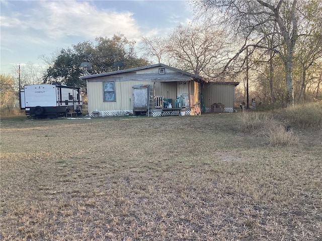 back of property featuring a yard