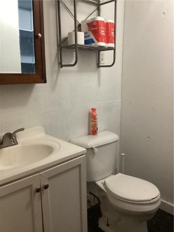 bathroom with toilet and vanity