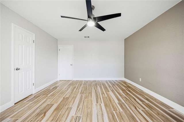 empty room featuring ceiling fan and light wood-type flooring