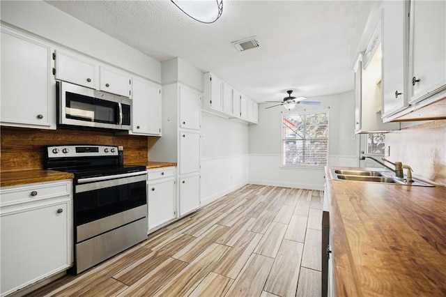 kitchen featuring appliances with stainless steel finishes and white cabinets