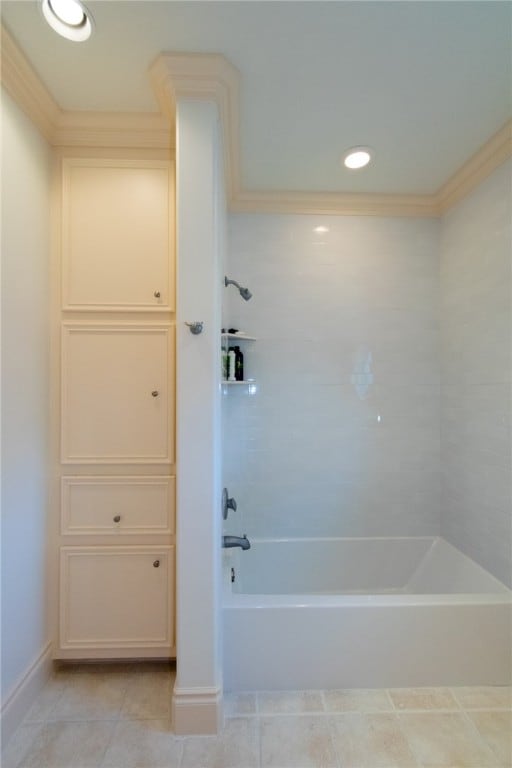 bathroom with ornamental molding, tile patterned flooring, and tiled shower / bath combo