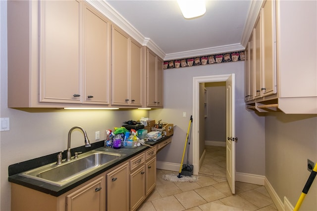 kitchen featuring sink, light tile patterned floors, and crown molding