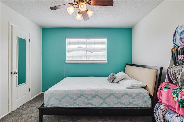 carpeted bedroom with ceiling fan and a textured ceiling