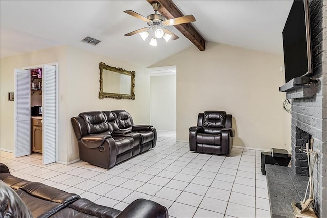 tiled living room featuring a brick fireplace, ceiling fan, and vaulted ceiling with beams