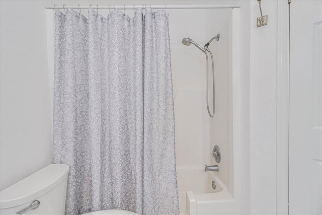 bathroom featuring toilet and shower / tub combo with curtain