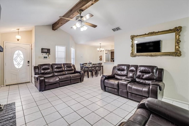 tiled living room with lofted ceiling with beams and ceiling fan with notable chandelier