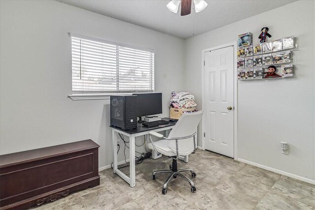 home office featuring a textured ceiling and ceiling fan