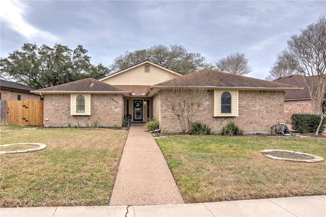 ranch-style house with brick siding, a front lawn, fence, and a gate