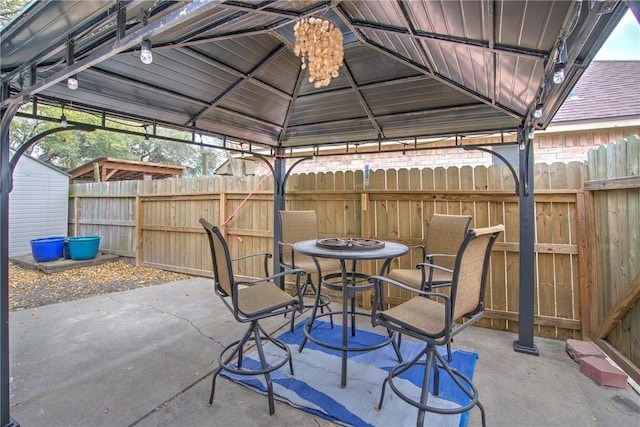 view of patio with fence and a gazebo