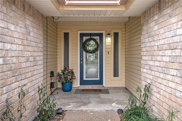 property entrance featuring brick siding